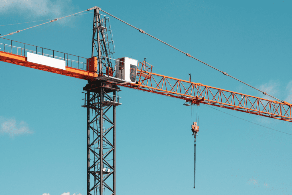 Two Workers Stand High Off The Ground Near Their Cab To Earn Their Crane Operator'S Salary In Canada
