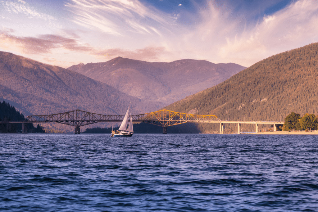 A Sail Boat On Kootenay Lake Close To Big Orange Bridge The Pros And Cons Of Living In Nelson Bc Canada On Kootenay Lake