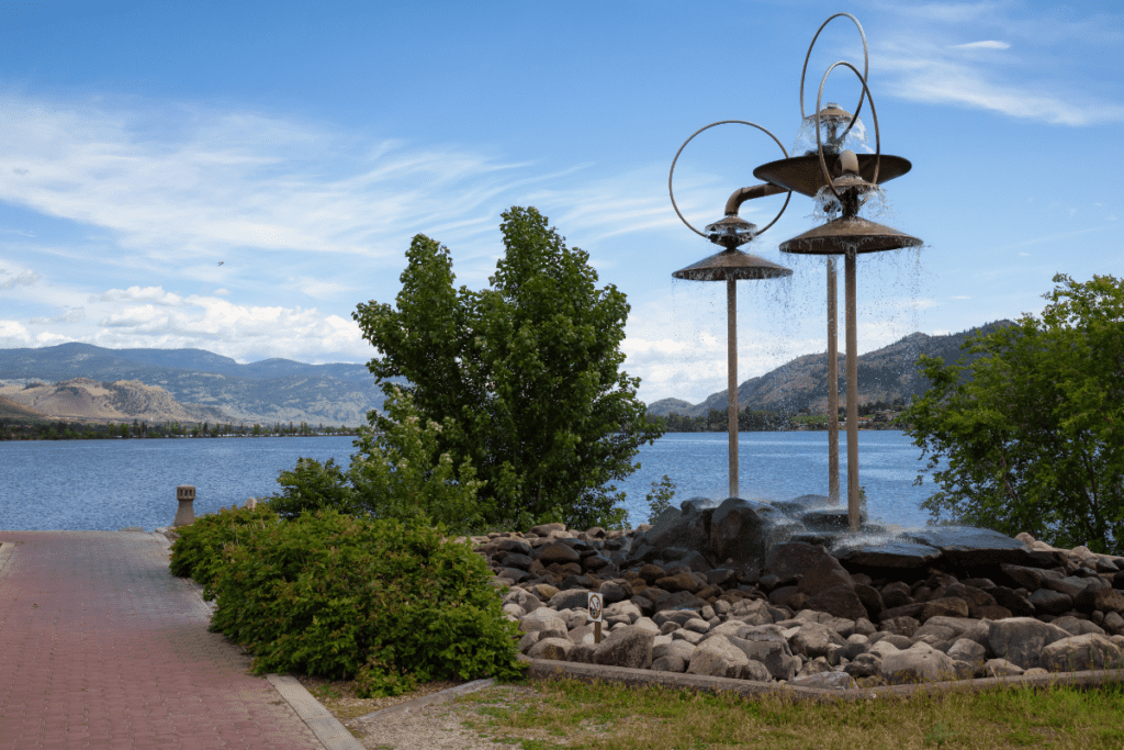 Osoyoos Lake Lakefront On A Beautiful Summer Day With Mountains And Vineyards In The Background As An Example For Living In Osoyoos Bc Canada