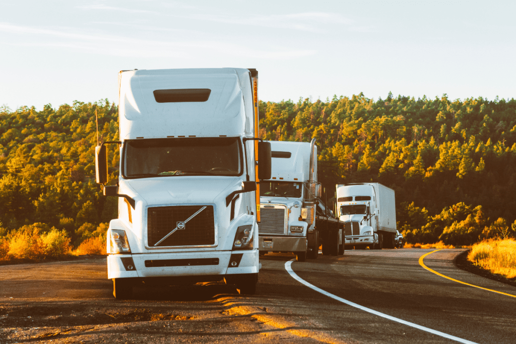 Three White Trucks On Road On Sunny Fall Day Transport Supervisor'S Salary In Canada