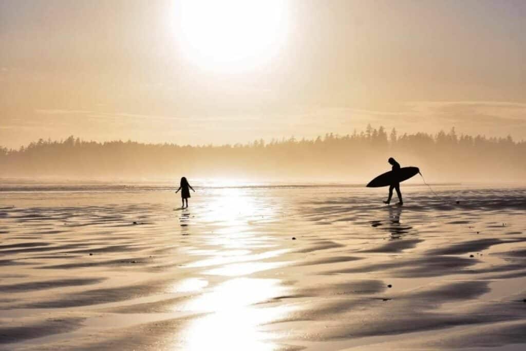 Surfer And Young Girl On Beach At Sunset Near Tofino One Of The Best Reasons To Move To Bc